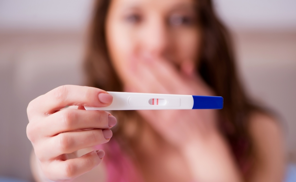 a woman with pregnancy test kit